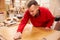 Carpenter Finishing Wood In Carpentry Workshop