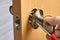 Carpenter fixes interior door handles using screwdriver