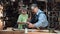 Carpenter with grandson working in workshop