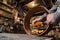 Carpenter grinding wooden drum shell from inside with sandpaper