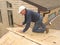 Carpenter installing sheathing to roof