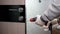 A carpenter installs an interior door in an apartment  a handyman drills a door lock  a young man makes repairs in an apartment.