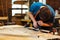 Carpenter Making Wooden Furniture in Shop