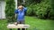 Carpenter man put protective glasses and mask on and start polishing wood board