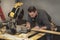 Carpenter marking line on wood board during home remodel constructionn project