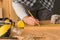 Carpenter marking pine wood plank for cutting