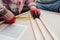 Carpenter measures plywood boards