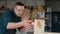 Carpenter measures wooden planks in the workshop.