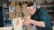 Carpenter measures wooden planks in the workshop.