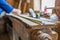 Carpenter measuring a long oak board, focus on the ruler