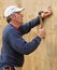 Carpenter nailing plywood