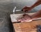 The Carpenter nailing wood board to make furniture