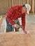 Carpenter pounding nail into interior wall