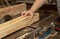 a carpenter processes wood on a machine