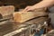 a carpenter processes wood on a machine