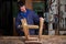 Carpenter restoring Wooden Stool Furniture in his workshop.