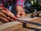 Carpenter with ruler measuring wood. profession, carpentry, wood