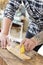 Carpenter sanding a guitar neck in wood at workshop