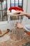 Carpenter sanding a stool and a Santa hat