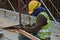 Carpenter sawing timber at the construction site