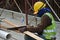 Carpenter sawing timber at the construction site