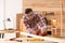 Carpenter shaping bar with hand plane at table in workshop