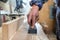 Carpenter sharpens a chisel in a small workshop,