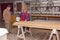 Carpenter smears the plywood with hand roller tool, spreader for evenly application of glue on the wooden surface