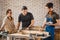 Carpenter with students in woodworking workshop