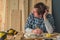 Carpenter thinking in small business woodwork workshop interior