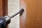 The carpenter uses a flat bit shank drill for wood to drilling a handle hole with a lock for an interior door