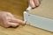 Carpenter uses white plastic furniture assembly dowel pin, close