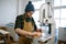 Carpenter using band saw to cut plywood, closeup shot with selective focus