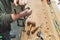 Carpenter using brace. Adult male woodworking expert using manual drill to create a hole in a piece of wood. High angle