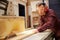 Carpenter Using Circular Saw In Carpentry Workshop