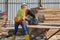 Carpenter using circular saw at the construction site