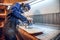 Carpenter using circular saw for cutting wooden boards.