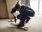 A carpenter using a drill on a wood