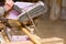 Carpenter is using hand held circular saw to cut boards, making clean precise cut