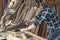 carpenter using saw hand cutting wooden plank in workshop . Young man builder sawing board . craftsman wearing protective mask and