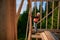 Carpenter using spirit level while constructing wooden frame house.