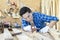 A carpenter is using a wood sharpener. Carpenter builder handles a wooden plank board plane in the workshop