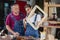 A carpenter woman and man works in her own woodworking shop. Carpenter work on wood plank in workshop. small business concep