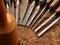 Carpenter wood chisel tools on old weathered wooden workbench