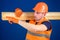 Carpenter, woodworker, strong builder on busy face carries wooden beam on shoulder. Man in helmet, hard hat and