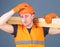 Carpenter, woodworker, strong builder on serious face carries wooden beam on shoulder. Safety and protection concept
