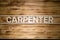 CARPENTER word made of wooden letters on wooden board