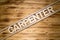 CARPENTER word made of wooden letters on wooden board