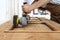 Carpenter work the wood with the sander grinding electric tools