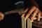 Carpenter at workbench nails down small wooden box.Hands of worker with old axe.Authentic workflow in carpentry workshop